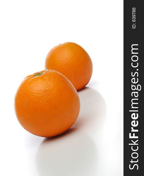 A pair of juicy oranges, one on front and one backwards over a white background. Look at my gallery for more fruits and vegetables