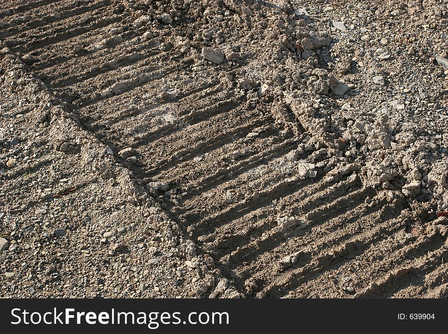 Abstarct of tyre tracks in earth for background.