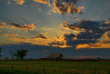 Beaming Sunset Over Rustic Barn Stock Photo