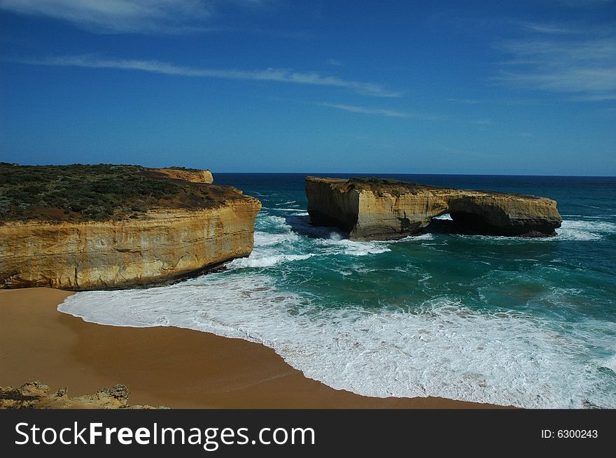 A bridge shape cliff standing out of the ocean. A bridge shape cliff standing out of the ocean