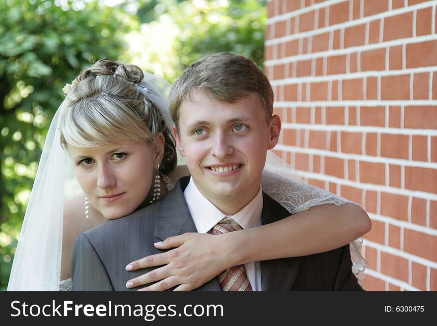 Happy newly-married couple on walk in park