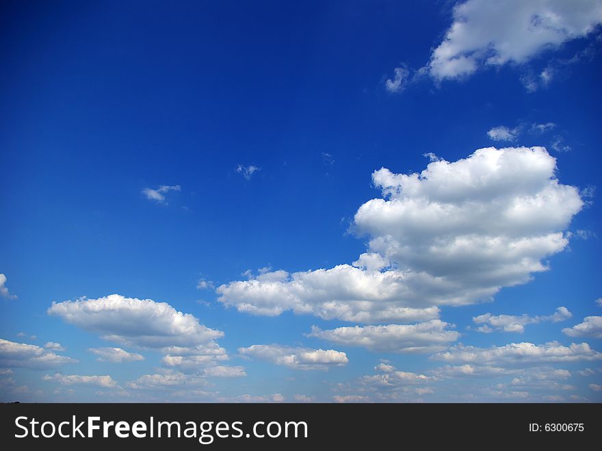 Blue sky background with tiny clouds