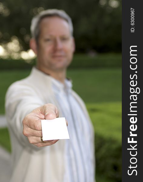 Young man giving a blank business card