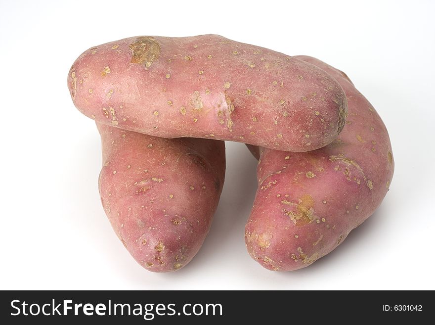 Three purple potatoes on white background