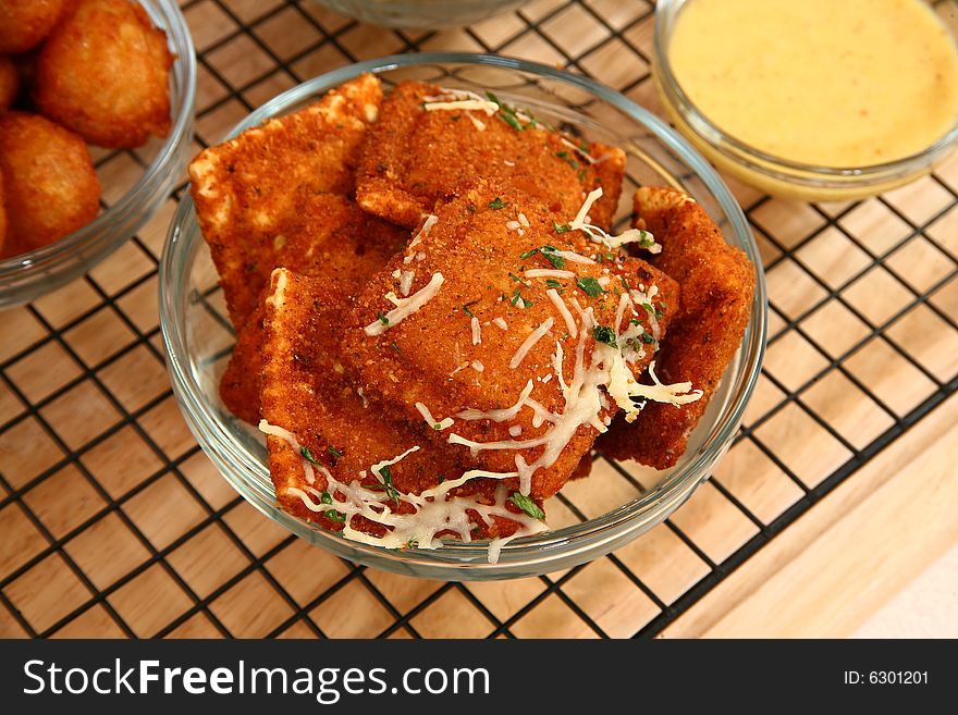 Fried ravioli in kitchen or restaurant with sauces. Fried ravioli in kitchen or restaurant with sauces.