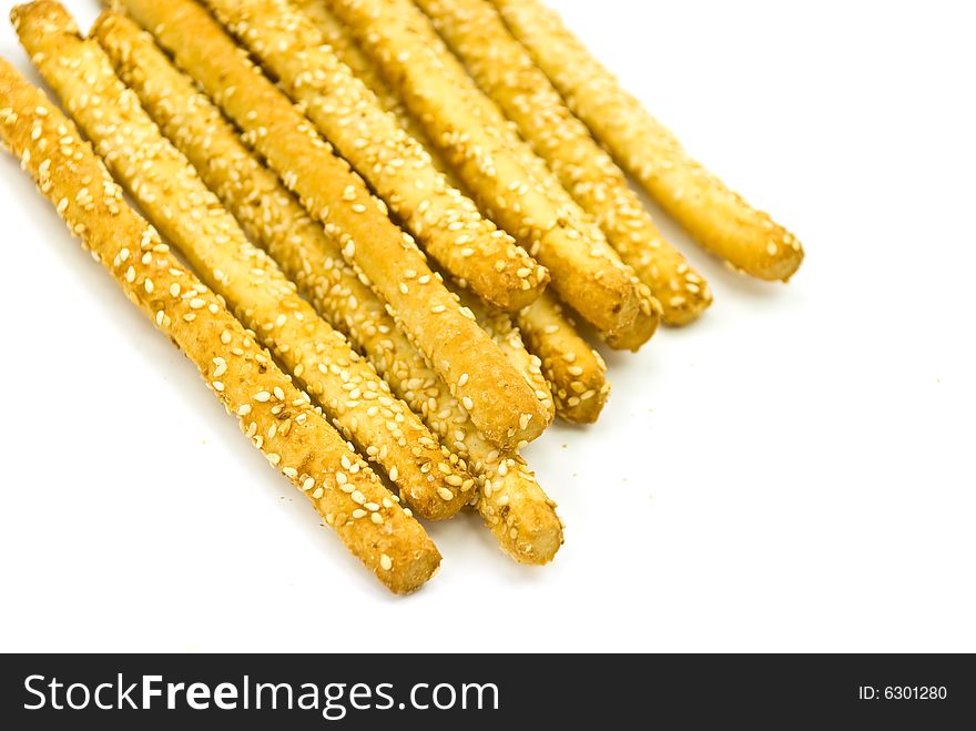 Many breadsticks with sesame - isolated on the white background.