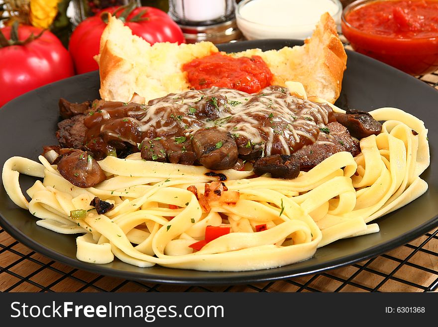 Thin slices of sirloin saut�ed with onions and peppers with creamy brown
gravy and mushrooms. Thin slices of sirloin saut�ed with onions and peppers with creamy brown
gravy and mushrooms.