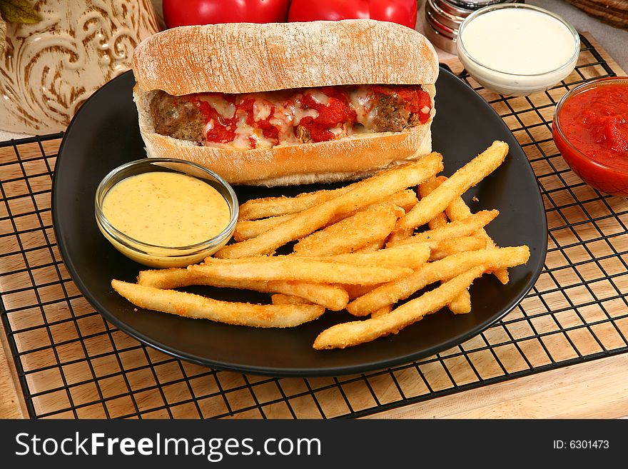 Italian meatball sandwich, spicy fries and honey mustard sauce. Italian meatball sandwich, spicy fries and honey mustard sauce.