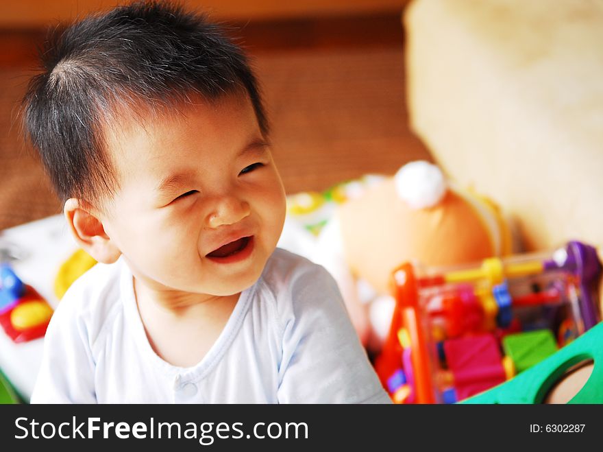 The cute baby is laughing.