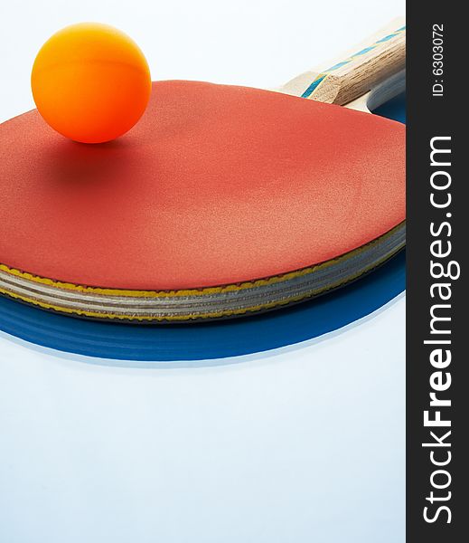 Tennis racket and orange ball on a blue background