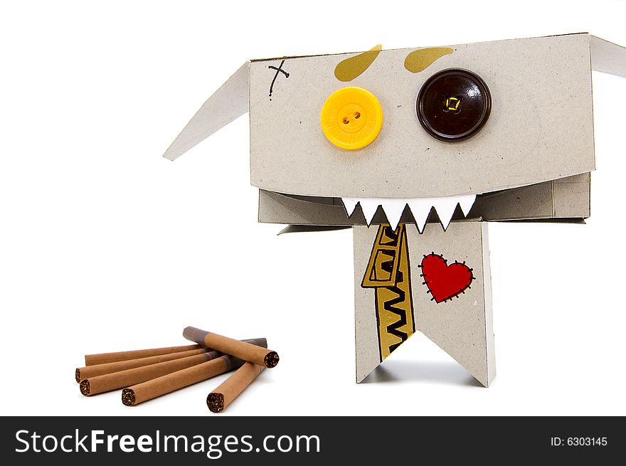 Brown cigarettes and funny expressive cardboard toy. Brown cigarettes and funny expressive cardboard toy
