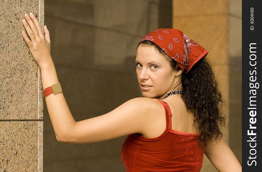 Portrait of pretty brunet woman  near column