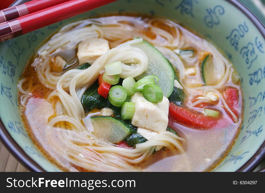 A japanese soup with vegetables and somen noodles. A japanese soup with vegetables and somen noodles