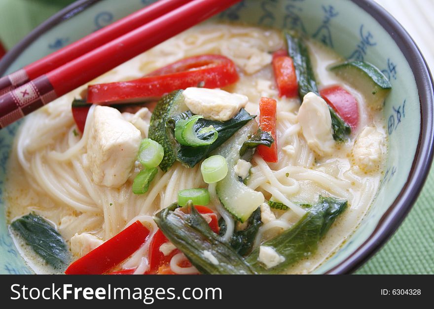 A asian meal with noodles, vegetables and tofu. A asian meal with noodles, vegetables and tofu