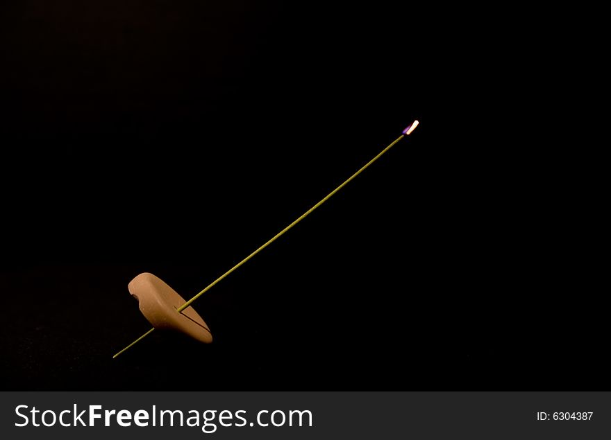 A stick of vanilla incense. Typical flame just after lighting it up. A stick of vanilla incense. Typical flame just after lighting it up.