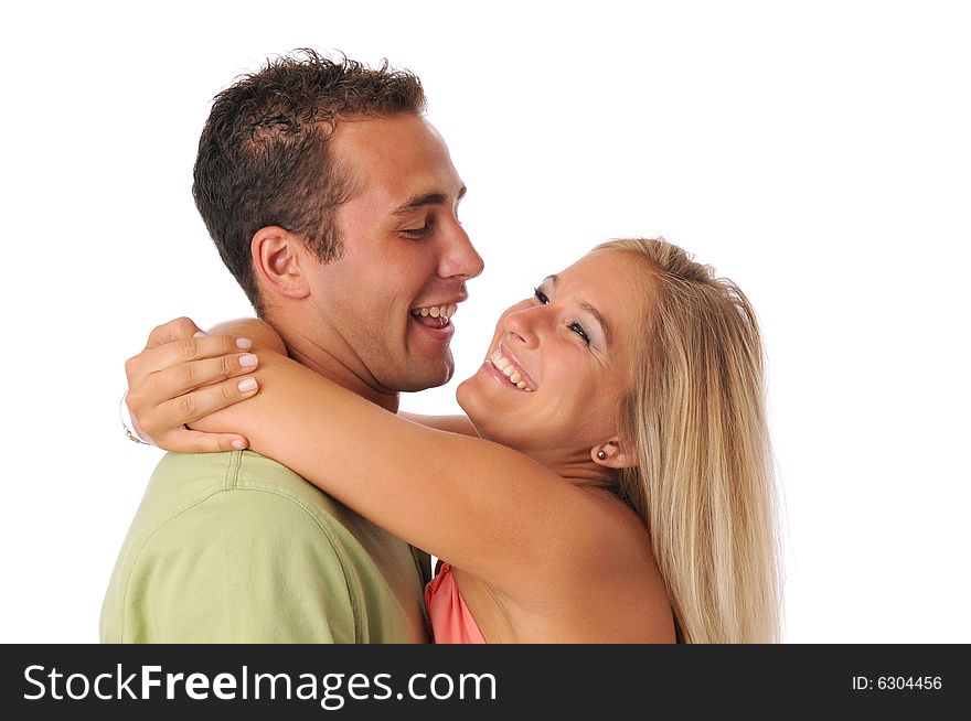 Young couple having fun while hugging isolated on white