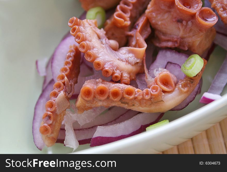 A fresh salad of octopus with red onions