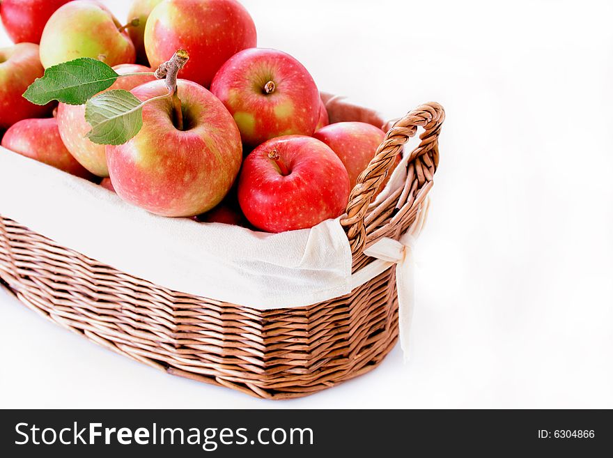 A basket of fresh picked apples isolated on white. A basket of fresh picked apples isolated on white.
