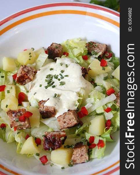 A fresh salad of potatoes, zucchinis and meat