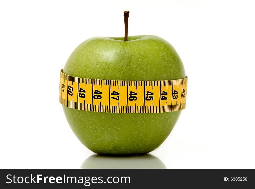 Fresh looking apple surrounded by measuring tape. Fresh looking apple surrounded by measuring tape