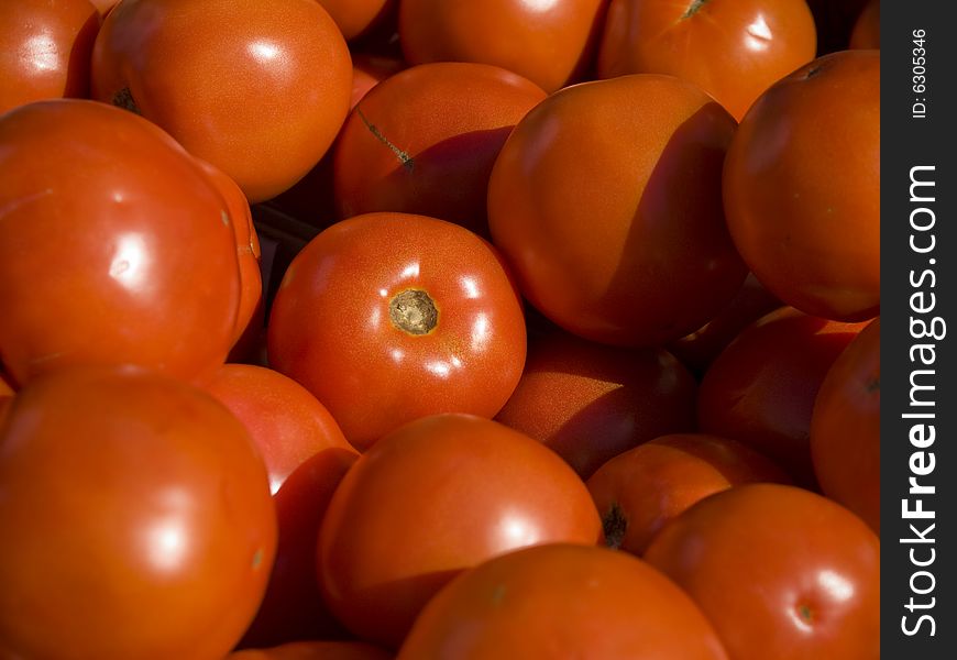Close up on a bunch of red tomatoes. Close up on a bunch of red tomatoes.
