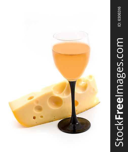 Yellow cheese with 
apertures and a wine-glass with wine on a white background