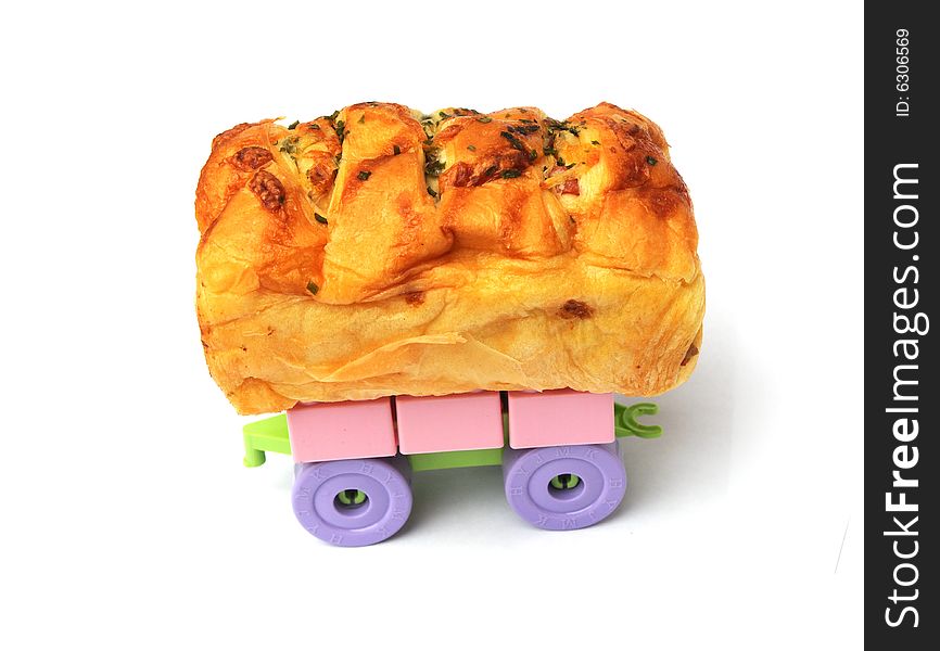 The bread with dried meat on the toy wheels. The bread with dried meat on the toy wheels.