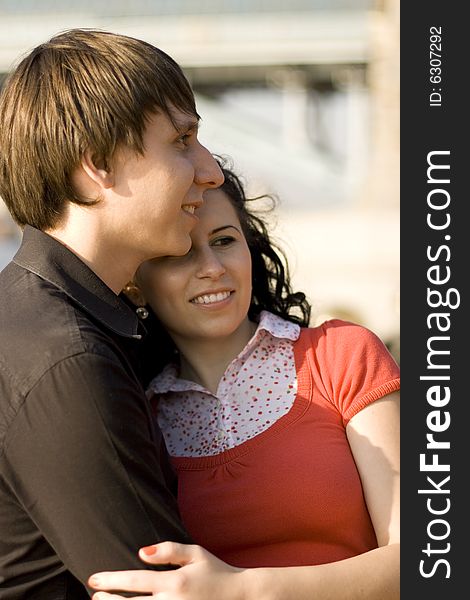 Outdoor portrait of young happy attractive couple together