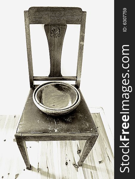 Old chair with antique bowl. Black and white.