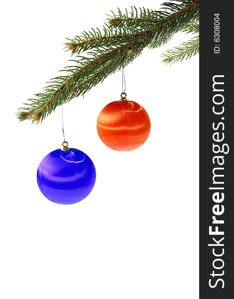 Red and blue christmas balls on spruce branch isolated on white. Red and blue christmas balls on spruce branch isolated on white