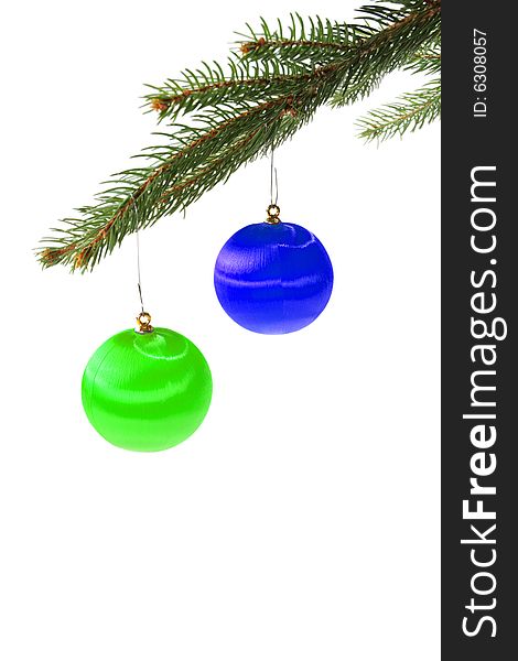 Green and blue christmas balls on spruce branch isolated on white. Green and blue christmas balls on spruce branch isolated on white