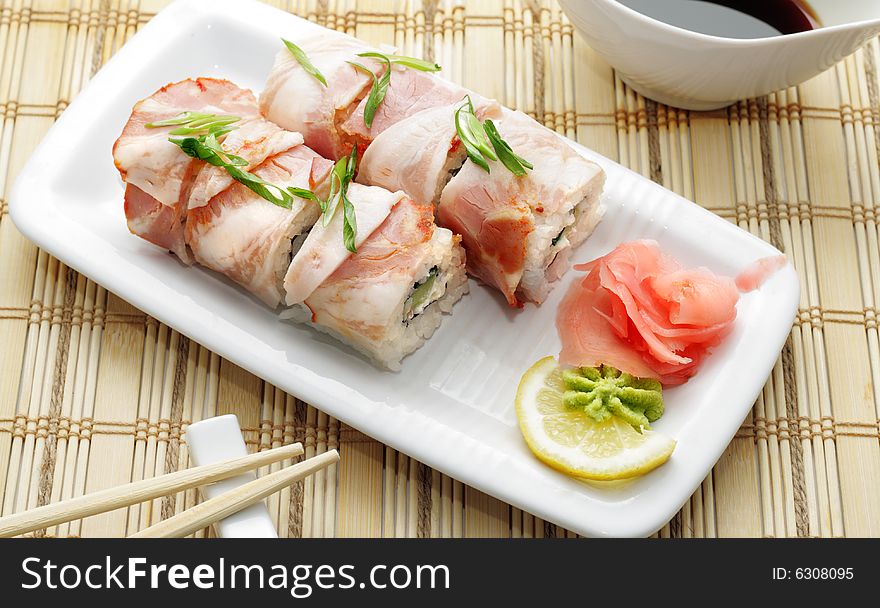 Roll in Bacon with Greens. Isolated on White Background. Roll in Bacon with Greens. Isolated on White Background