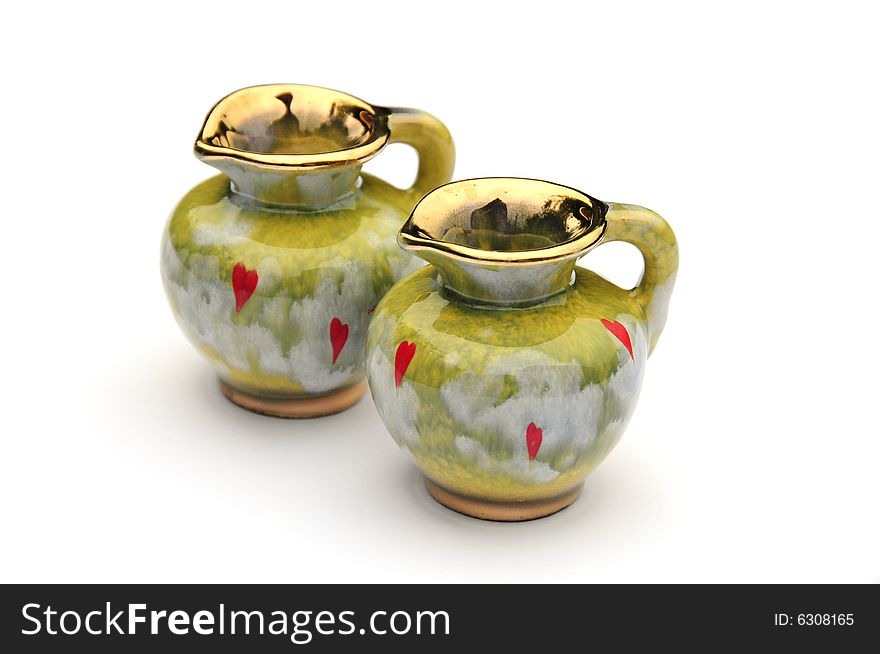 Two unusual green jugs on white background