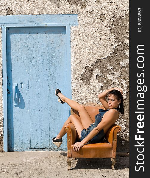 Sexy woman posing on old house