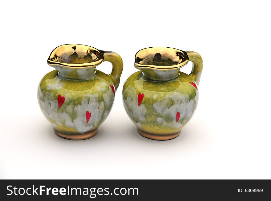 Two unusual green jugs on white background