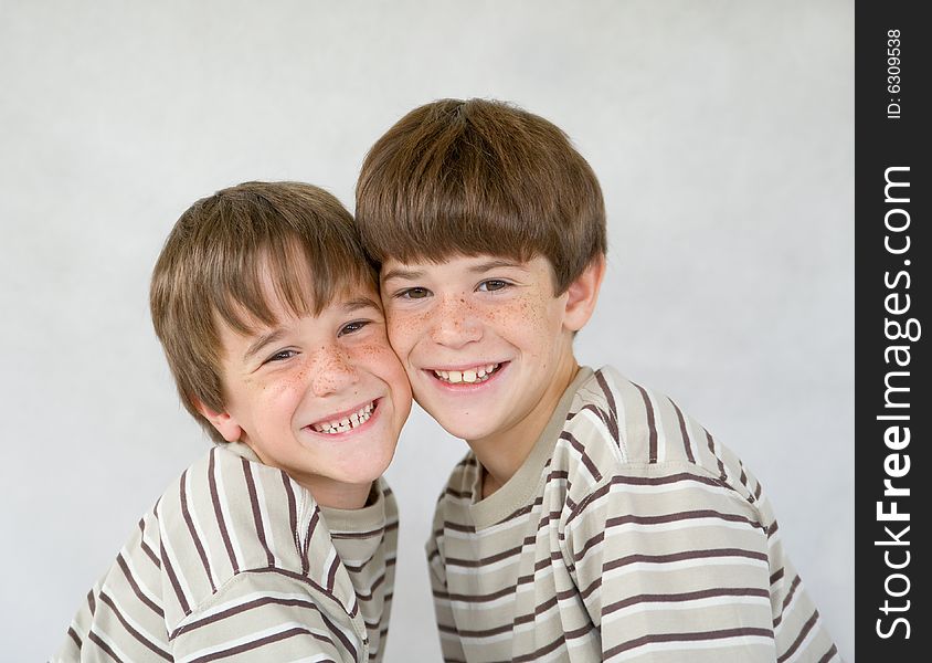 Brothers Against a White Background