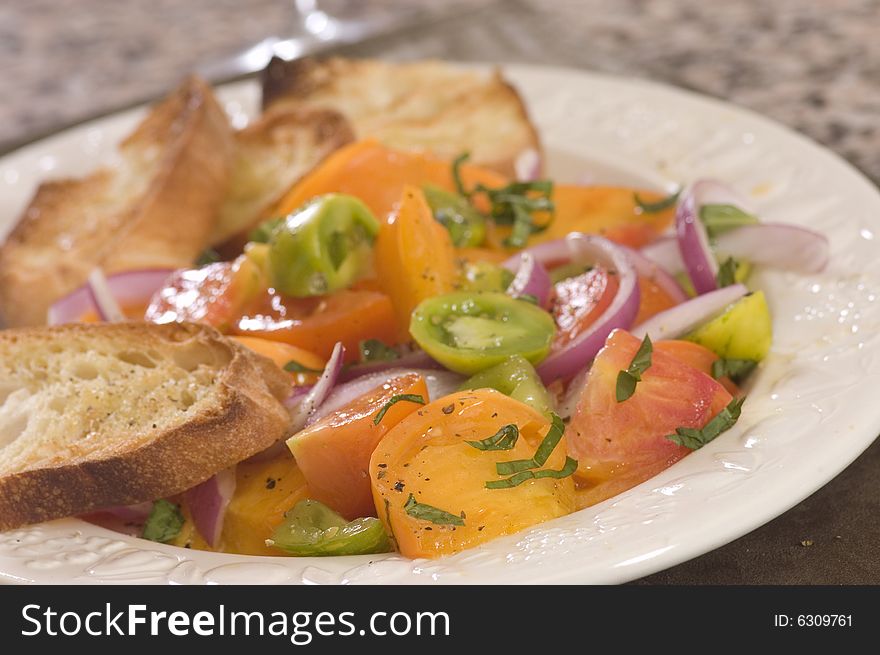 Plate of fresh tomato salad with toast