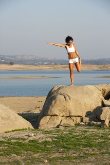 A Young Woman On Top Of A Rock Doing Yoga Stock Photo A Young Woman On Top Of A Rock Doing Yoga Stock Photo