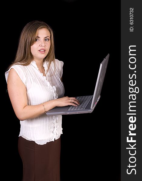 Young hispanic woman with a laptop isolated on black