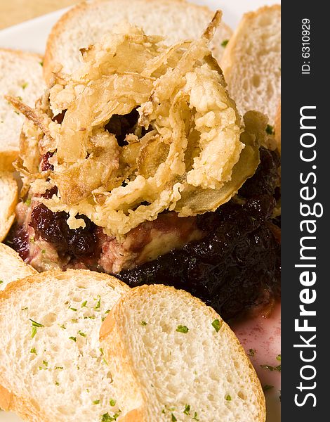 A pate plate with cranberry sauce and bread slices