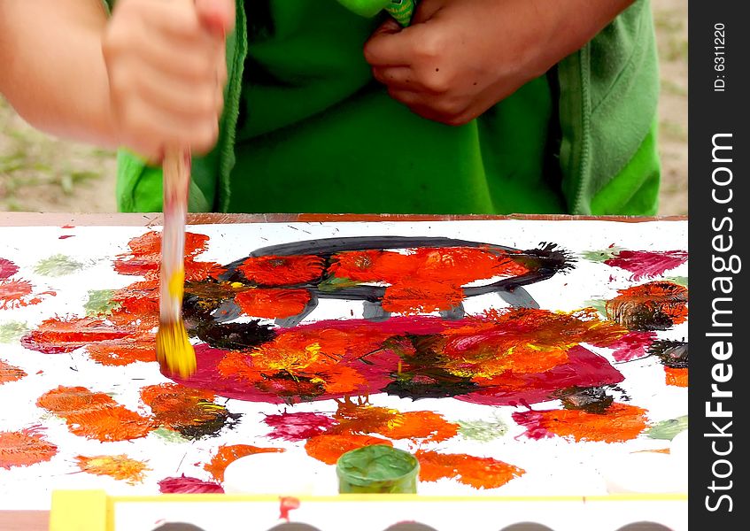 Kid painting the picture, colorful abstract