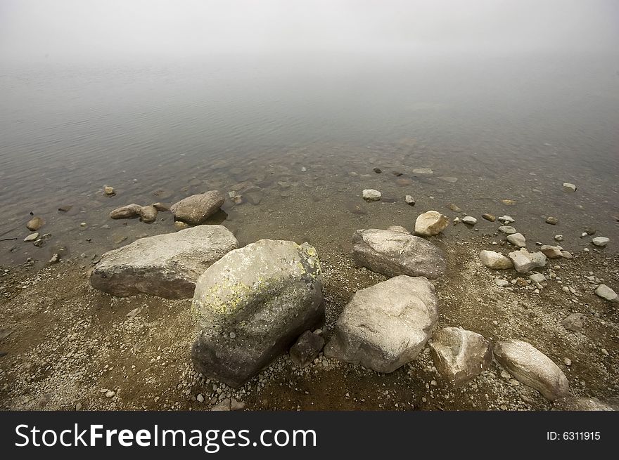 Mountain lake covered in mist, detail