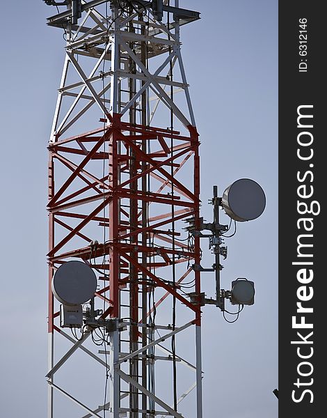 Telecommunications tower with satellite dish and cellular antenna. Telecommunications tower with satellite dish and cellular antenna