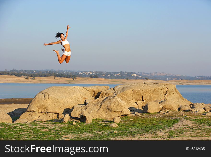 A woman jumps for joy