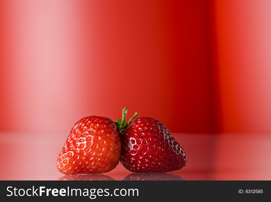 Close up view of nice fresh red berry on red back. Close up view of nice fresh red berry on red back