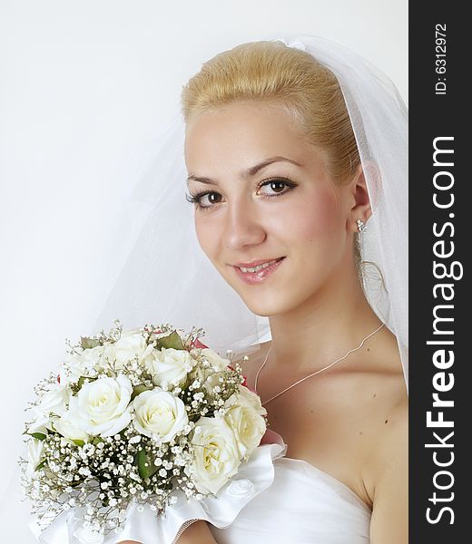 Portrait of beautiful bride with flowers studio shot
