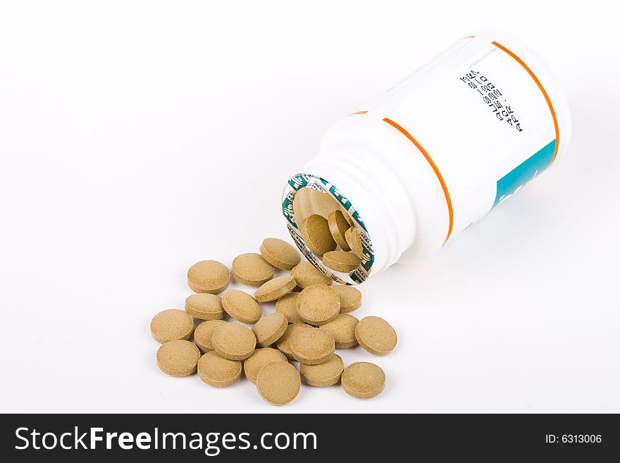 Pills spilling from bottle isolated