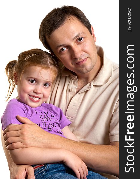 Lovely little daughter is sitting on the laps of her father. Lovely little daughter is sitting on the laps of her father