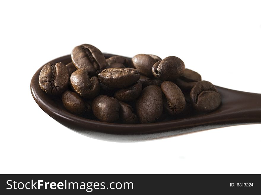 Spoon full of coffee, white background