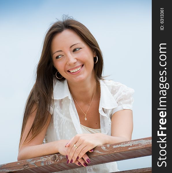 Portrait of a young cute woman sitting outdoors. Portrait of a young cute woman sitting outdoors